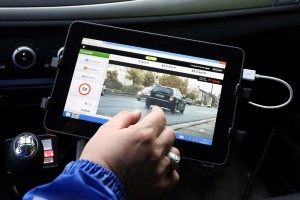 A gendarme controls the speed of motorists using the new generation of  radars in an unmarked vehicle on June 13, 2013 in Saint-Andre de Cubzac.  AFP PHOTO/ NICOLAS TUCAT