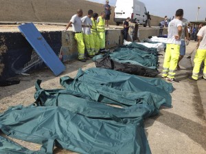 Body bags containing African migrants, who drowned trying to reach Italian shores, lie in the harbour of Lampedusa